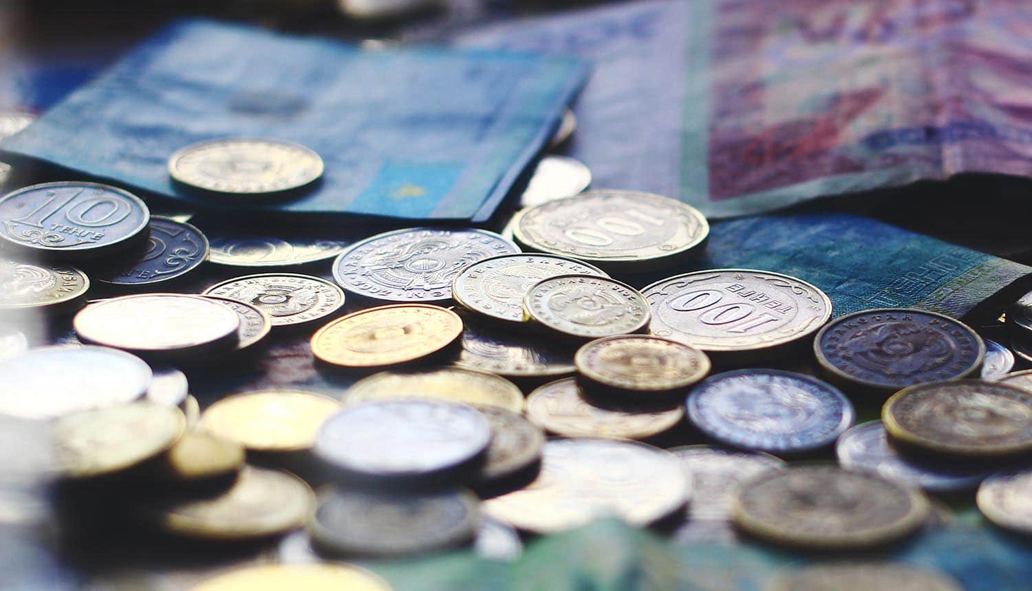 Currencies banknotes and coins showing evolution of cyber threats to international payment flows