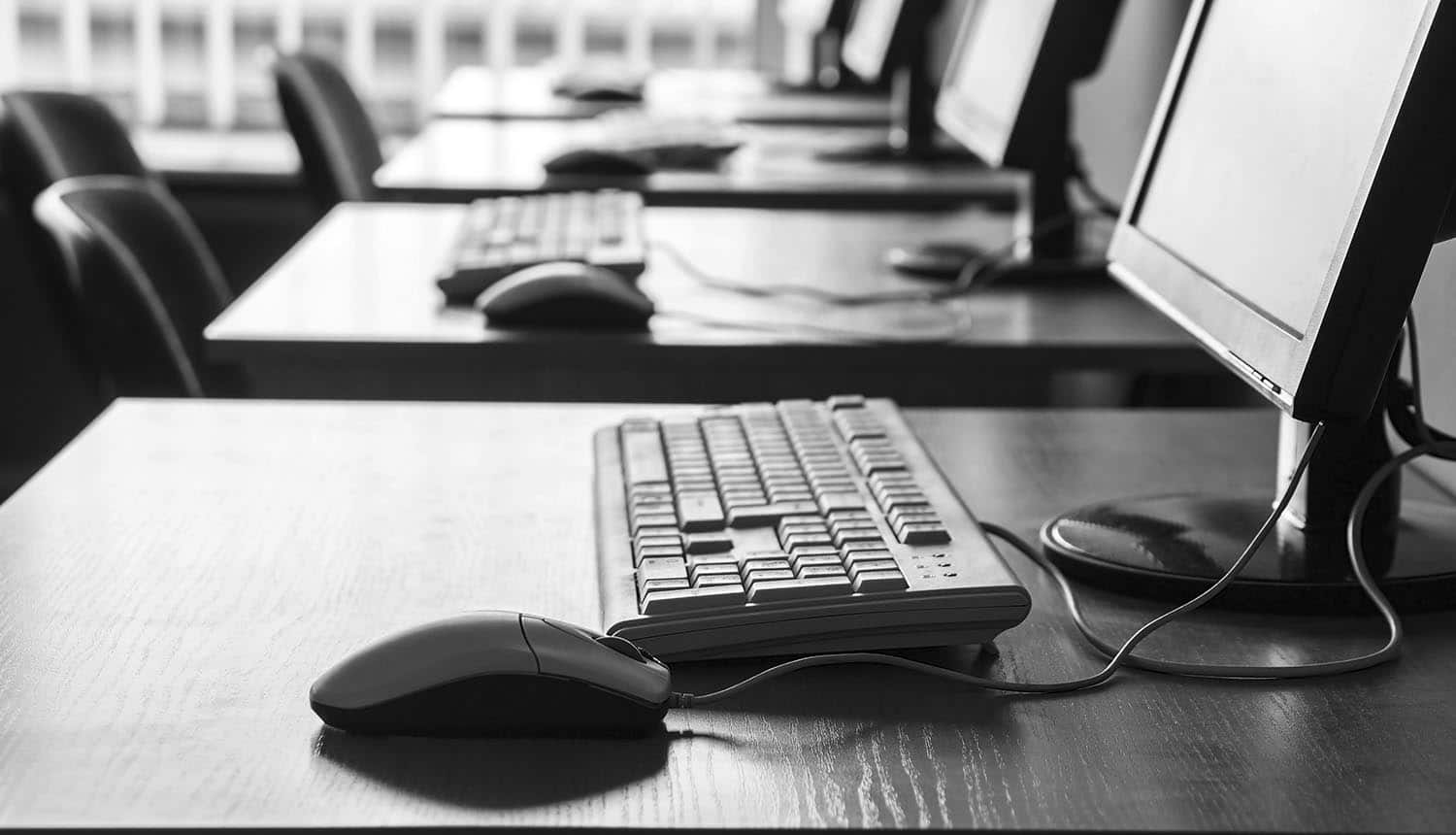 Computers in black and white showing that universities are still very vulnerable to cyber attacks