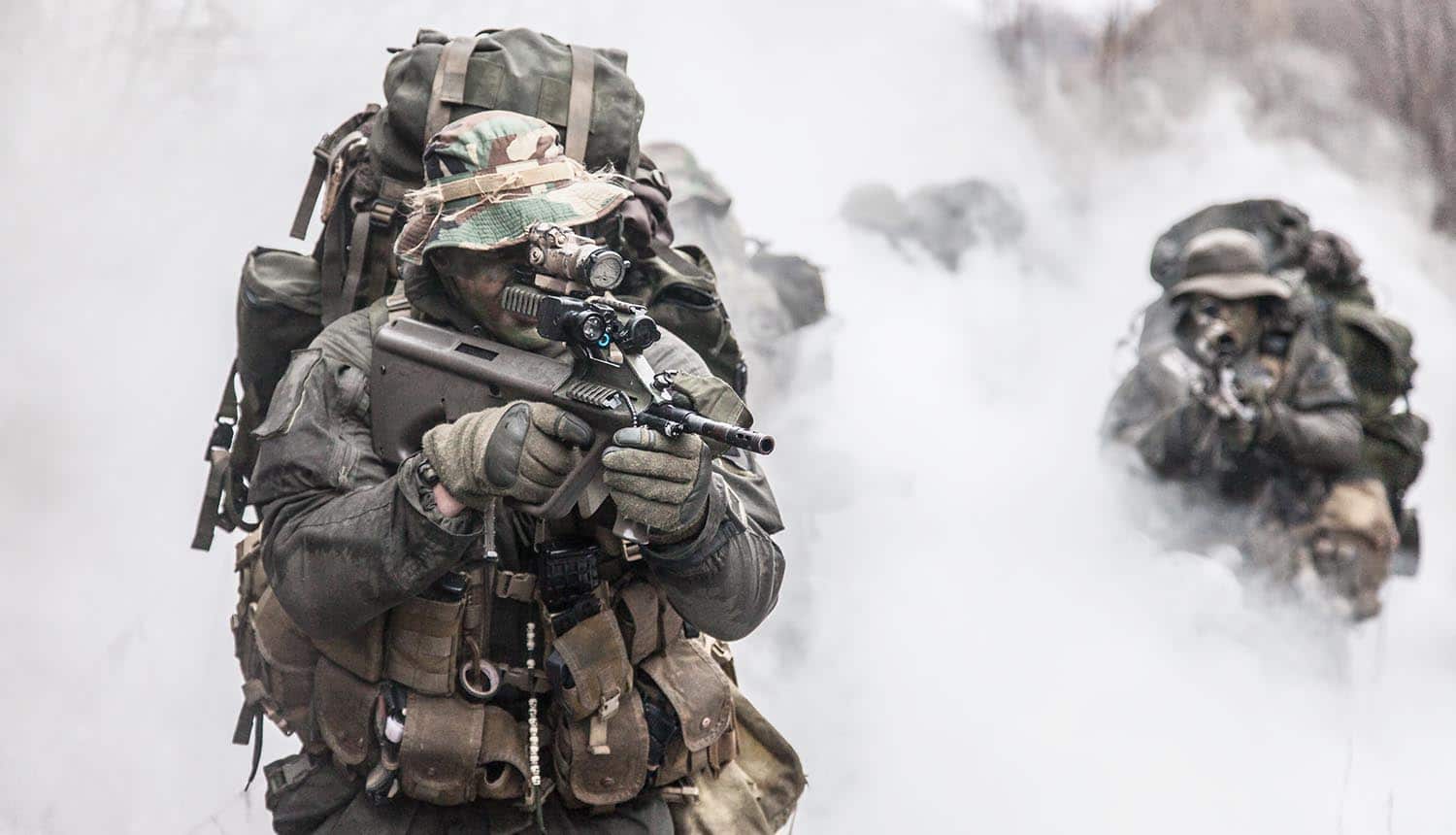 Group of soldiers in the smoke showing the use of active cyber defense with private sector bounty hunters