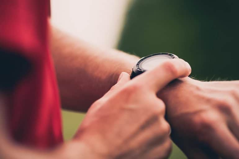 Runner using heart rate monitor smartwatch showing continuing concerns with IoT security and privacy