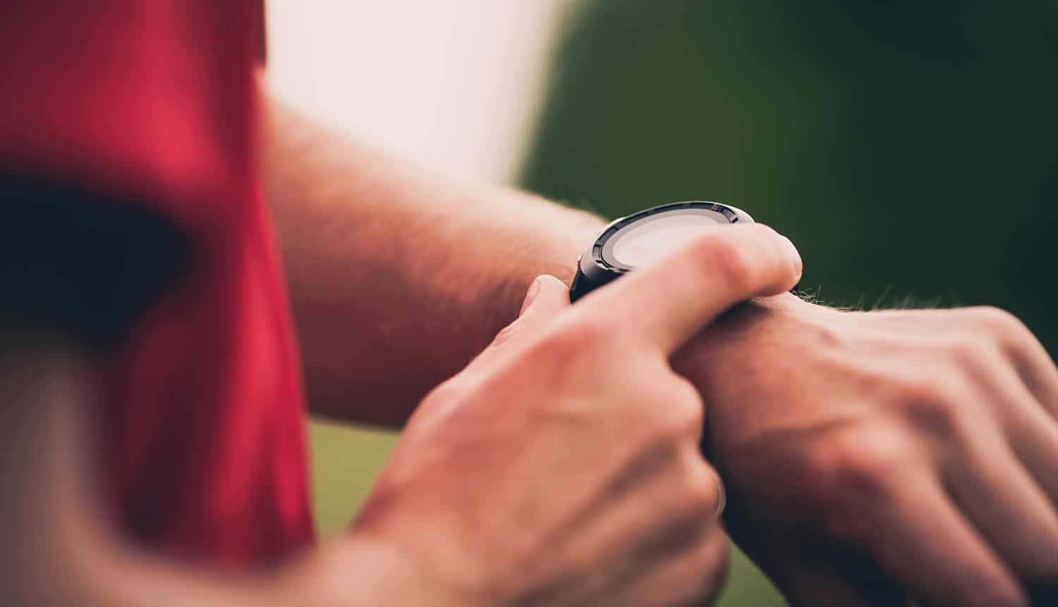 Runner using heart rate monitor smartwatch showing continuing concerns with IoT security and privacy