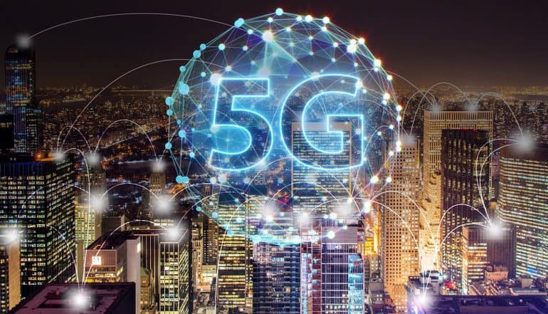 5G connectivity map against city night scene showing growing concerns for IoT security in 5G networks
