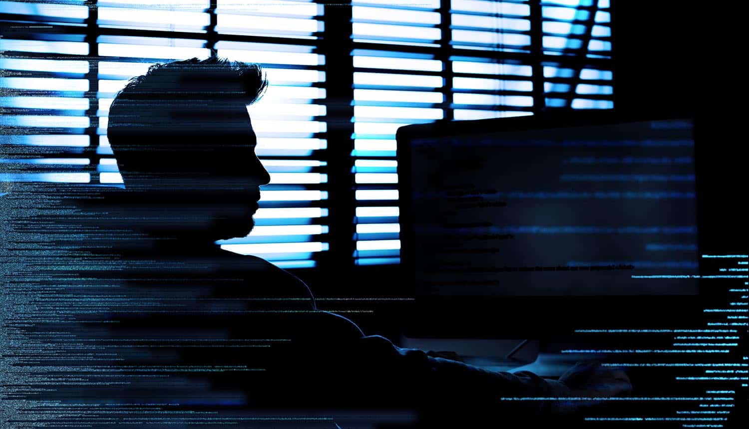 Hacker behind computer showing how tools and source code used by Iranian hackers were exposed