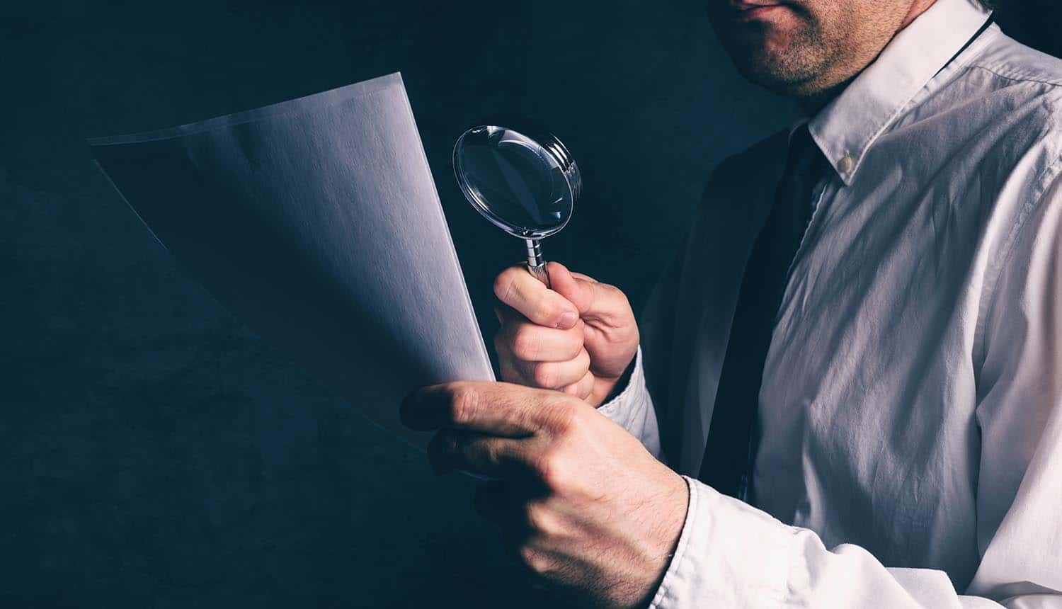 Man using magnifying glass to read CDN and infrastructure providers’ privacy policies