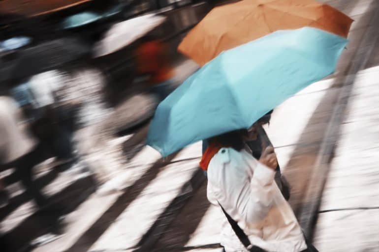 Two women under umbrella showing cyber insurance companies lagging behind to provide customer needs and protect against emerging threats