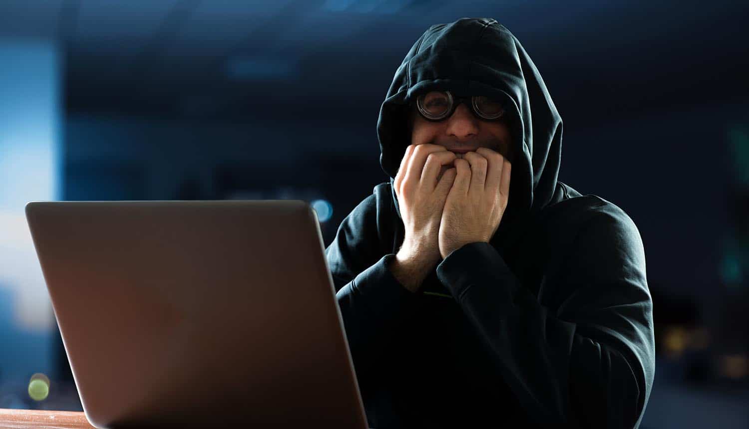 Man in shock with computer showing the unknown cyber threats to company data assets