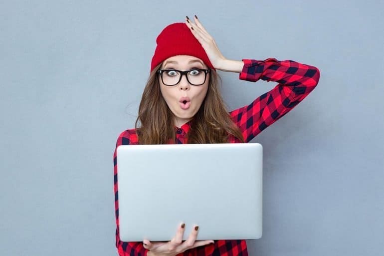 Funny woman holding laptop computer showing need to take care of privacy settings for Windows 10