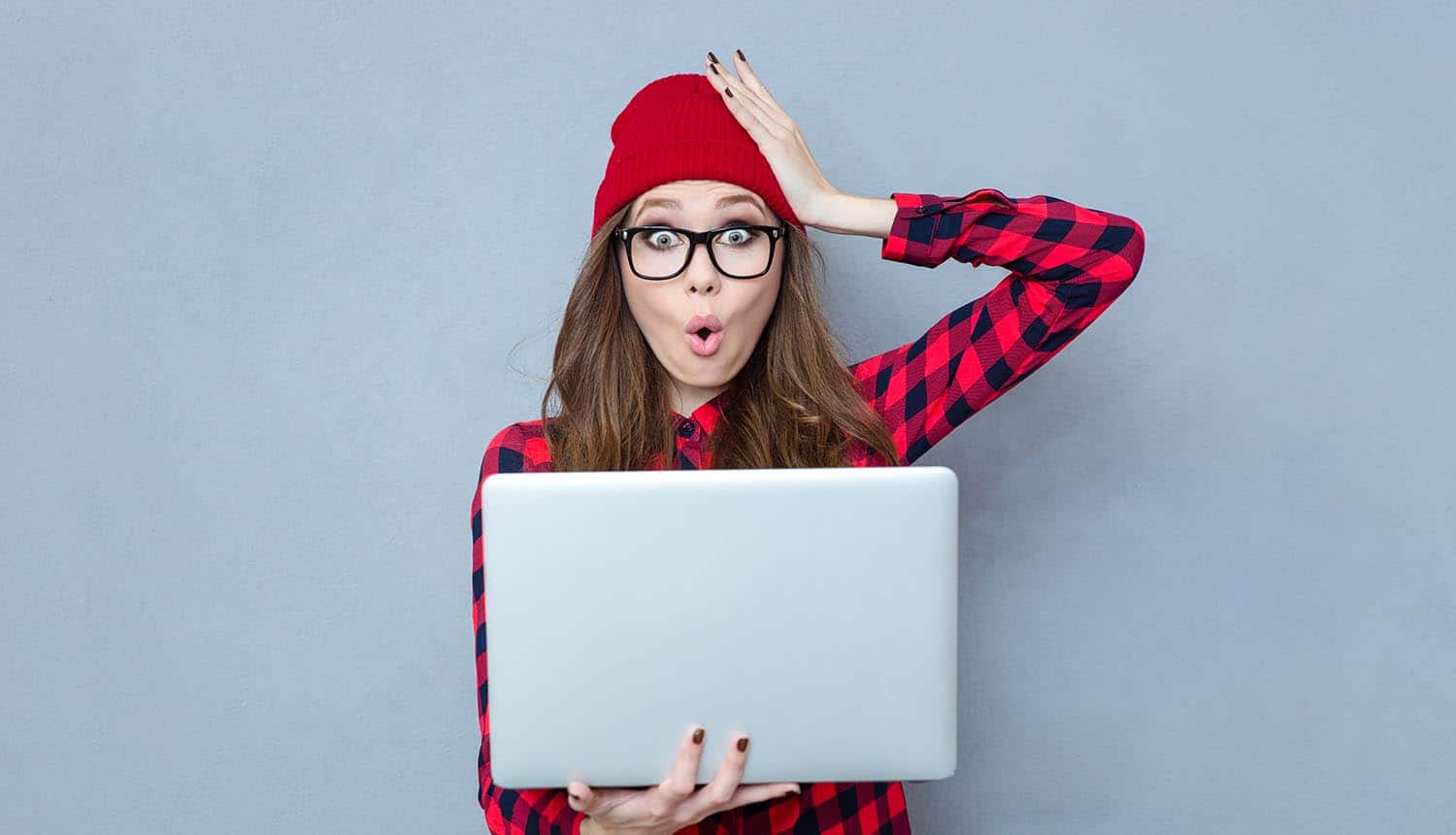 Funny woman holding laptop computer showing need to take care of privacy settings for Windows 10