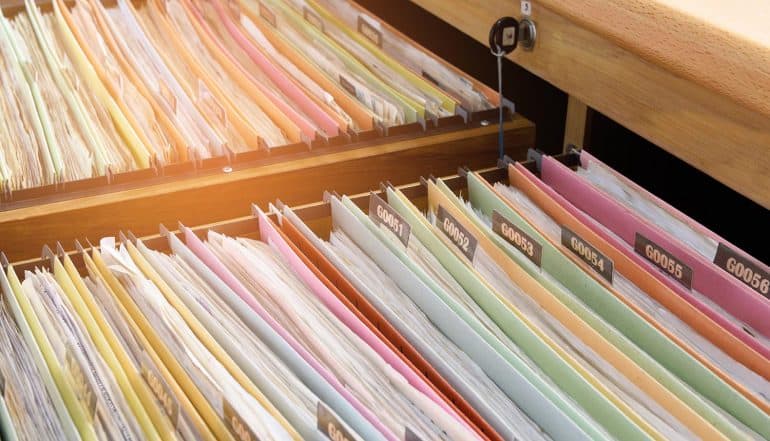 Documents in filing cabinets showing how AMCA healthcare data breach could set a new precedent for health IT security