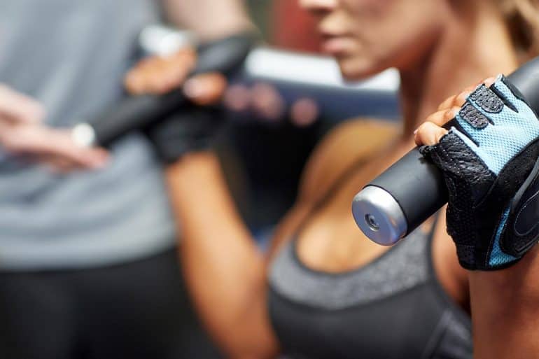 Woman and personal trainer working out showing CrossFit’s recent decision to delete Facebook and Instagram accounts over data privacy concerns