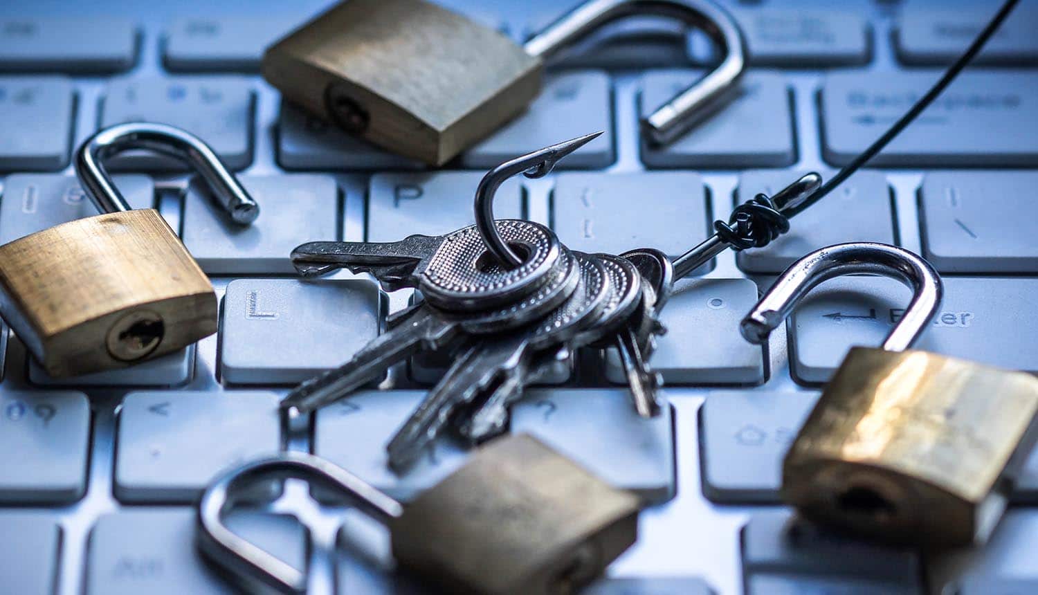 Keys on hook with opened padlocks on keyboard showing polymorphic phishing attacks making up almost half of phishing attempts