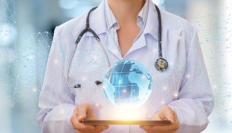 Doctor holding tablet with a network globe on top showing third party breach at Quest Diagnostics which exposed 12 million patient records