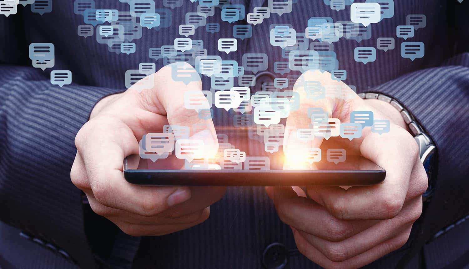 Man using phone with chat windows on top showing tech companies and civic organizations condemning GCHQ proposal on encrypted chats