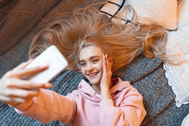 Young girl taking selfie showing FaceApp privacy seen as the type of drama we’ve come to expect from social media companies