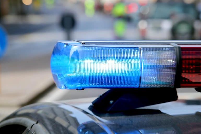 Police siren lights showing FBI and ICE using state driver’s license photos for facial recognition scans