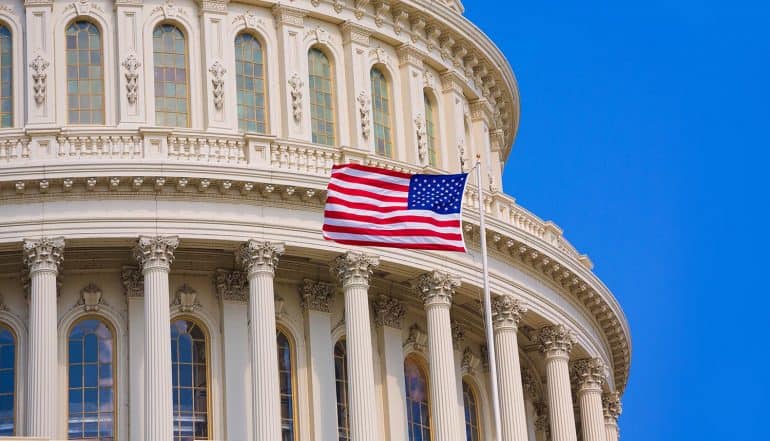 U.S. flag flying outside capitol building showing election security currently taken as high priority issue in U.S.