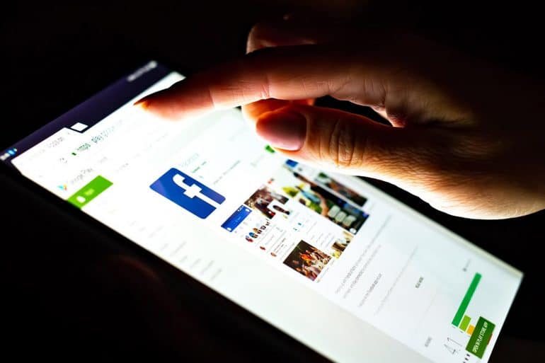 Woman using Facebook app on tablet showing the privacy concerns on Facebook and the action plan that they could have taken