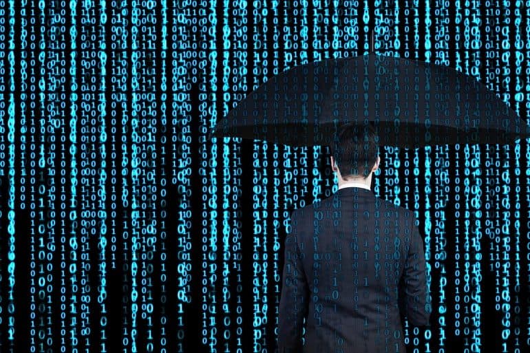 Man with umbrella against binary number background showing the risks in current cyber insurance market