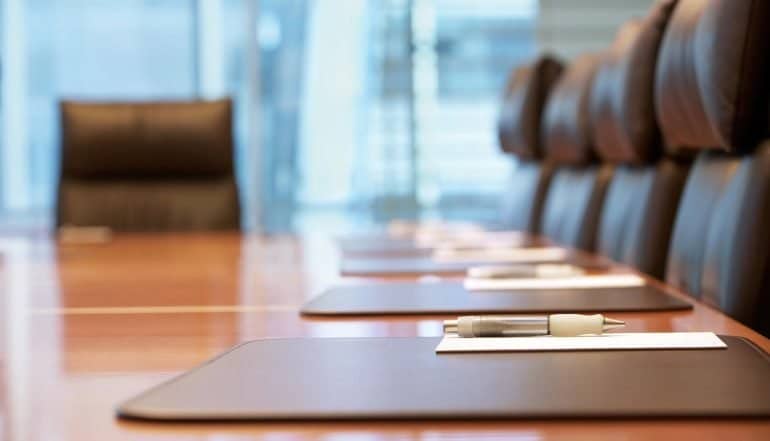 Picture of a conference room showing how cybersecurity leaders can effectively communicate and position security risks to their C-suite