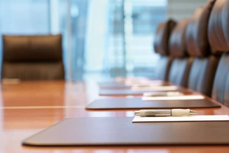 Picture of a conference room showing how cybersecurity leaders can effectively communicate and position security risks to their C-suite