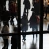 A crowd of people seen through a window showing the citizen data of 92 million Brazilians is offered for sale on underground forum