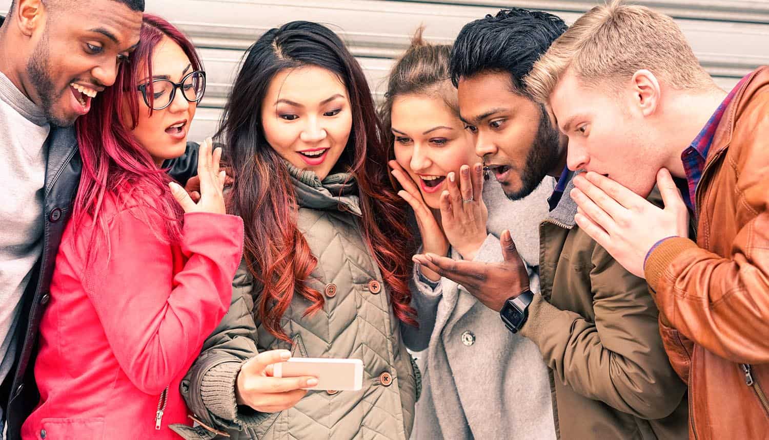 Few persons with surprised face looking at mobile showing majority of Americans have little knowledge on digital security and privacy as shown in new study