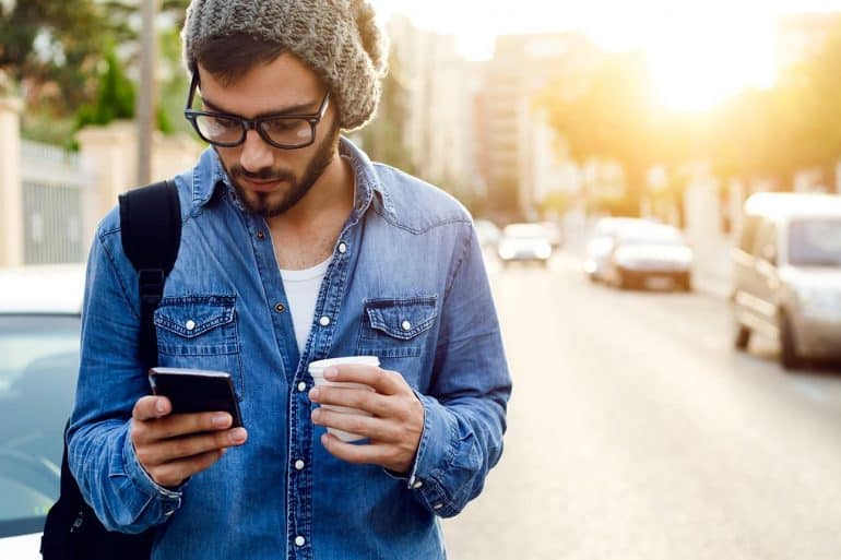 Traveller using mobile phone showing how the world’s most popular travel apps failed to meet basic security and privacy standards