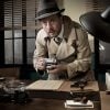 Spy photographing documents showing the ways to detect and remove stalkerware