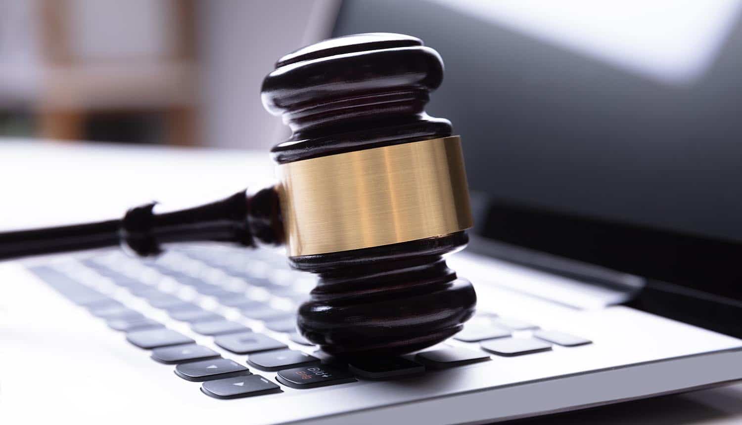 Close-up of wooden gavel on laptop showing new COPRA digital privacy act