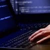 Man coding on laptop showing the implication of HiQ vs. LinkedIn case on automated web scraping