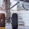 View of the landing gear under the airplane wing showing the impact of cyber attacks on RavnAir may ground their flights for a month