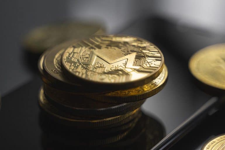 Stack of golden Monero coins showing increased crypto mining activities by North Korea