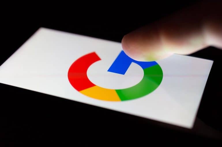 Smartphone lying on a table in the dark, displaying the logo of Google showing threat to GDPR protections post-Brexit