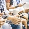 People using smartphone showing privacy behaviors of tech users