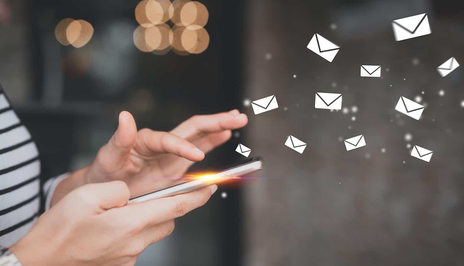 Woman using mobile with flying email icons showing the email data leak that is feeding information to advertising and analytics companies