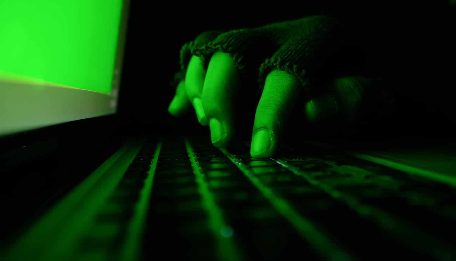 Hacker working on laptop showing the five-year cyber espionage campaign that targets Asia Pacific governments