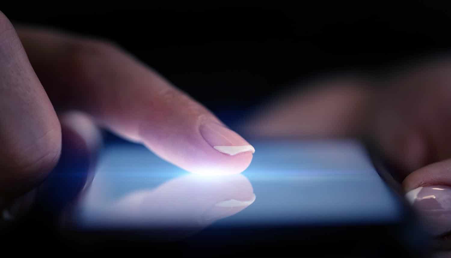 Finger touching Android phone showing new features of Anubis banking malware