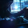 Hacker working on laptop showing the extent of underground hack-for-hire services with the unmasking of Dark Basin group