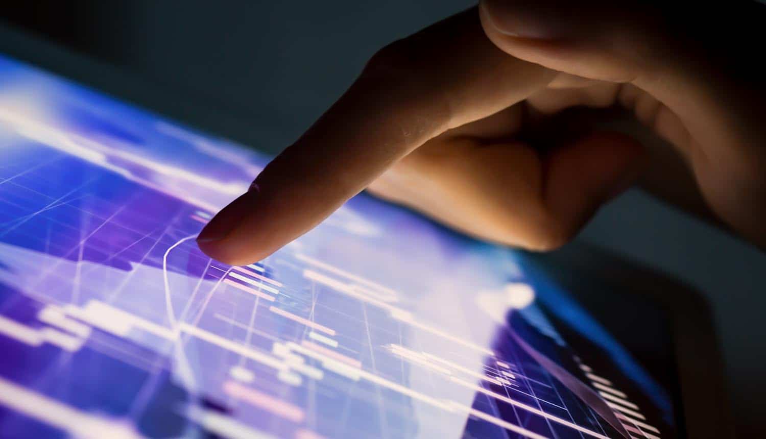 Man looking at graph on tablet showing increase in cyber losses and cyber security spending
