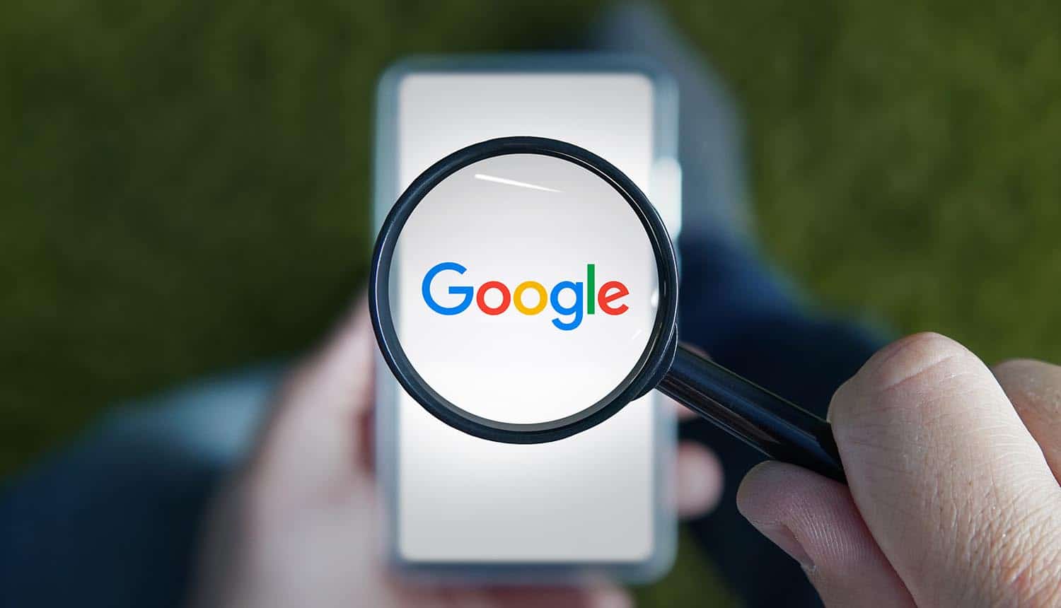 A man with a magnifying glass examines the Google logo on the smartphone showing privacy lawsuit on app tracking