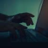 Hacker working on laptop showing the real cost of a data breach