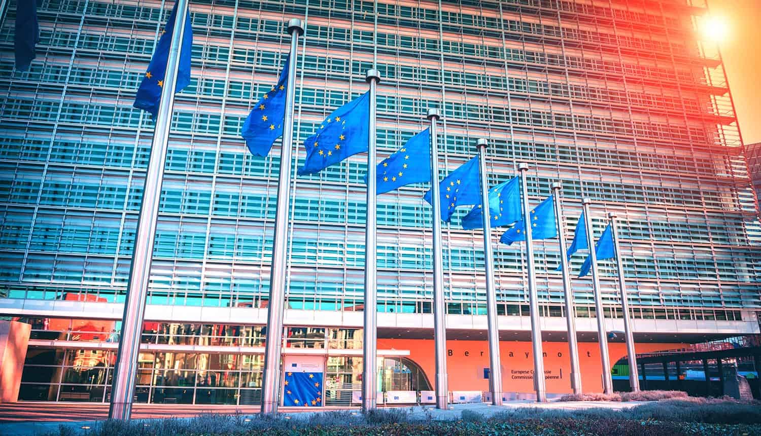 EU flags waving in front of European Parliament building showing invalidation of Privacy Shield