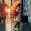 Woman with umbrella stands on the street near the store showing Clearview AI privacy lawsuit over facial recognition