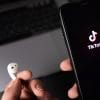 TikTok logo on smartphone screen showing probe by French privacy regulator