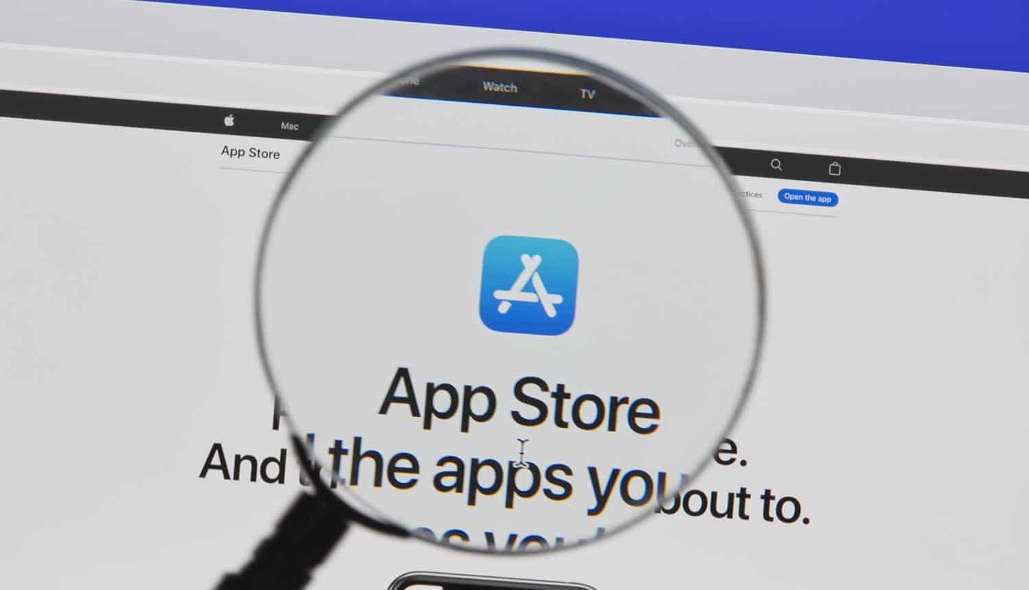 Closeup of Apple App Store website under a magnifying glass showing focus on security and privacy