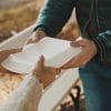 Old vulnerable homeless man getting free charity meal showing cybersecurity challenges