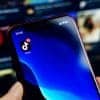 Person using TikTok on mobile phone showing TikTok profiles promoting scam apps