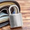 Padlock and wallet with money showing FinCEN rules on crypto wallets