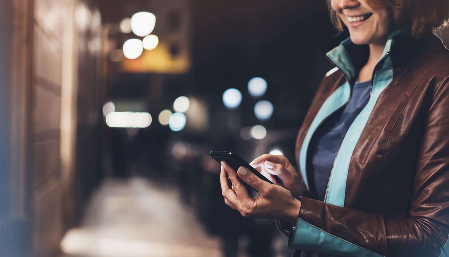 Woman smile and point finger on mobile app showing cyber threats during holiday shopping