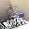 Shopping basket on laptop keyboard showing Magecart credit card skimmers on ecommerce platforms